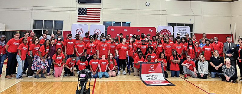 The dozens of students and staff involved in the H-F High Unified Program gathered for a photo with the Special Olympics banner. It's the second time H-F has received the honor, and is one of only five schools to be recognized. (Provided photo)