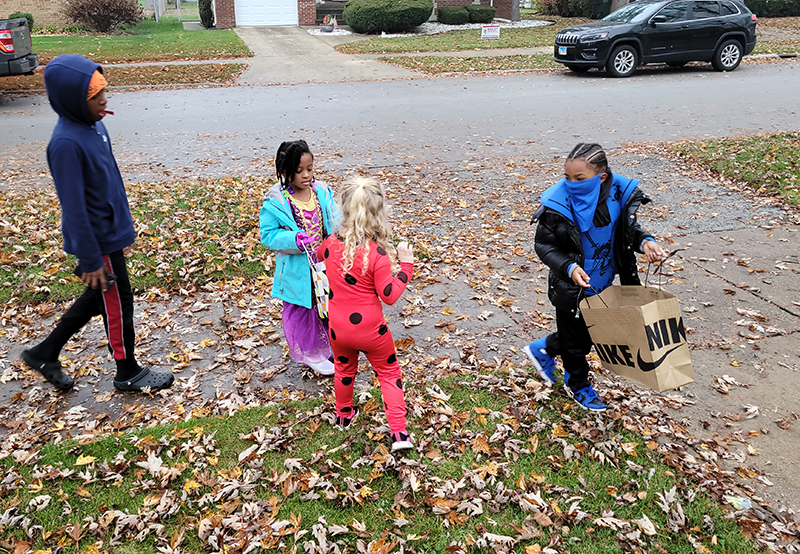Maggie Willis delivers candy to trick or treaters at her home on Page Avenue. (Eric Crump/H-F Chronicle)