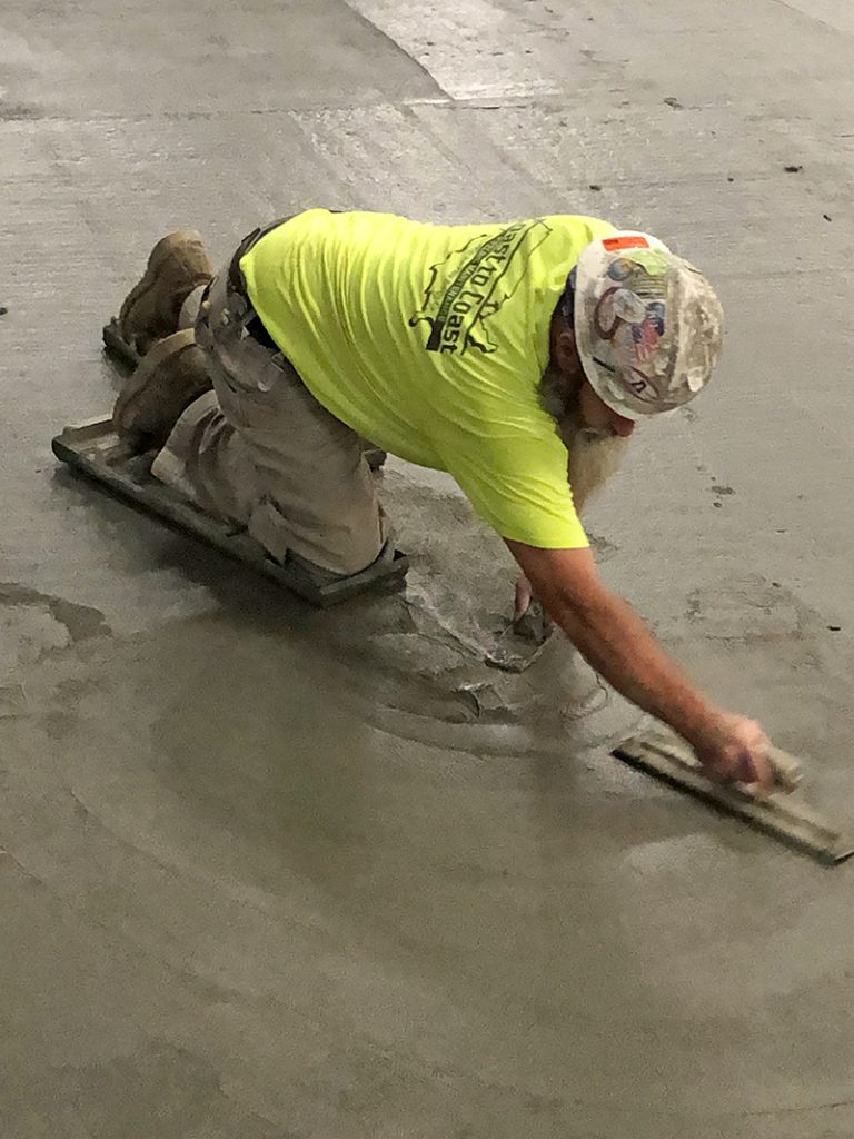 Concrete along the perimeter of the H-F Ice Arena was smoothed out by hand by crews from Rapin. (Marilyn Thomas/H-F Chronicle)