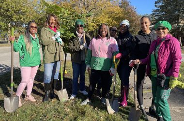 Members of the Alpha Kappa Alpha Sorority pose for a photo next to the first tree they planted in the Flossmoor Hills/Highlands neighborhood on Saturday, Oct. 15, during Plant the Gem. (Bill Jones/H-F Chronicle)