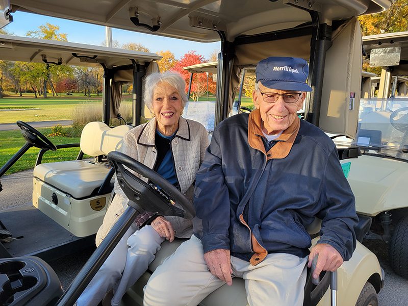 Beverly Goldberg, left, and Jerry Dreyfuss, former president of Ravisloe Country Club, prepare to head out on a tour of the golf course during an open house Monday, Oct. 24, to celebrate the property's designation as an arboretum. (Eric Crump/H-F Chronicle)