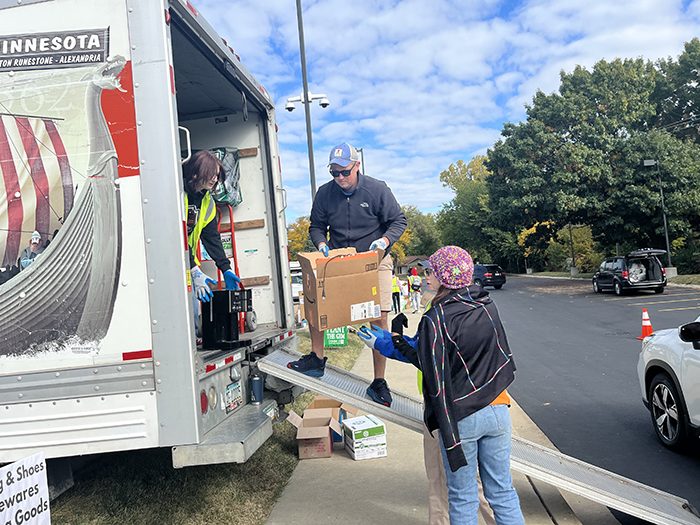 Volunteers load boxes of household items into truck during Recyclepalooza 2022. (Nick Ulanowski/H-F Chronicle)