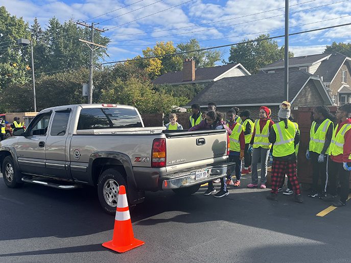 Student volunteers reach into the trunk of a pick up truck to remove donated items. (Nick Ulanowski/H-F Chronicle)