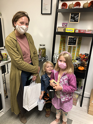 Nellsyn Bertke lets her daughters Lydia, center, and Marley select candy at Ruby Ella Sweets in the Shops on Sterling. (Marilyn Thomas/H-F Chronicle)