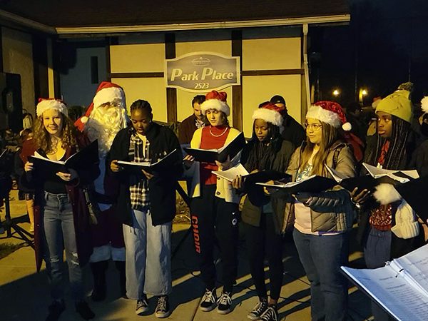 Santa Claus listens to the soaring voices of Homewood-Flossmoor High School singers just prior to the tree-lighting ceremony in Flossmoor Park on Nov. 26. (Eric Crump/H-F Chronicle)