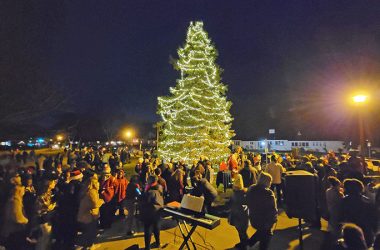 The crowd enjoys the illumination from Flossmoor's community Christmas tree after the lighting ceremony on Nov. 26. (Eric Crump/H-F Chronicle)