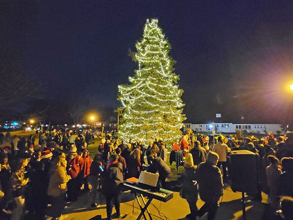 The crowd enjoys the illumination from Flossmoor's community Christmas tree after the lighting ceremony on Nov. 26. (Eric Crump/H-F Chronicle)