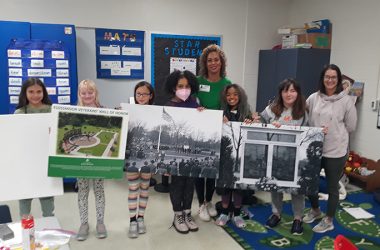 Girl Scouts from Troop No. 65547 hold images associated with the Flossmoor Veterans Memorial project. The Scouts are contributing to the project by helping find local veterans' names and stories. From left, Annabelle Salazar, Nora Rouse, Avery Cheung, parent helper Carla Lee, Julia Lee, Nadine Martin and troop leader Karen Cheung. (Provided photo)