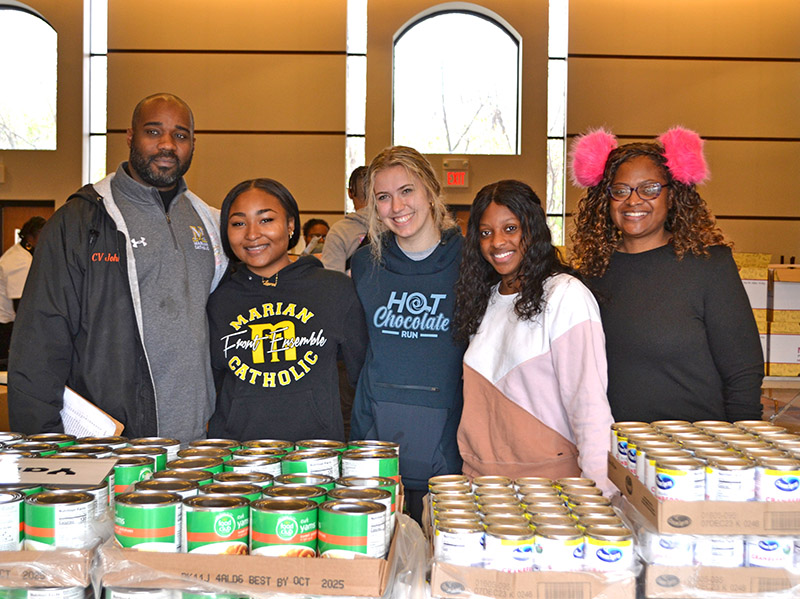 From left, Marian Catholic Campus Minister Curtis Johnson, Junior Lauren Richardson of Chicago Heights, Senior HaleyTrojan of Olympia Fields, Junior Kylie Kimbrough and her mom, Tameka Berry, of Olympia Fields. (Provided photo)