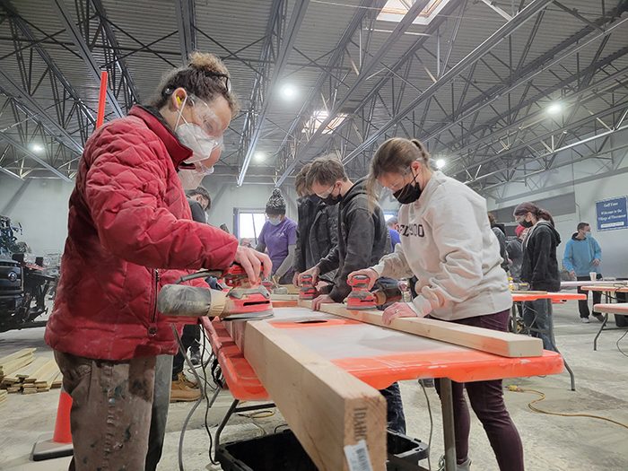 Build a Bed 2022-01-16 012 Cari Anderson, left, and Flossmoor Mayor Michelle Nelson work on sanding pieces of bed frame. (Eric Crump/H-F Chronicle)