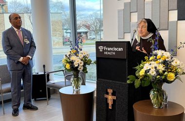 Sister Jane Marie Klein, chairwoman of the Franciscan Alliance Board of Trustees, right, speaks during a blessing and dedication ceremony on Nov. 30 for the new Family Medicine and Walk-In Clinic in Chicago Heights as Raymond Grady, president and chief executive officer of Franciscan Alliance’s South Suburban Chicago Division, looks on. (Provided photo)