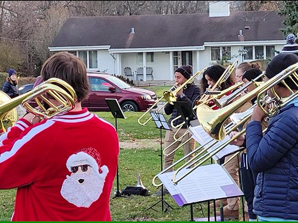 The South Suburban Trombone Choir performs its first set of the afternoon in Flossmoor Park. The group later moved to the lawn of Flossmoor Library to continue entertaining the crowd at Flossmoor's holiday festival. (Eric Crump/H-F Chronicle)