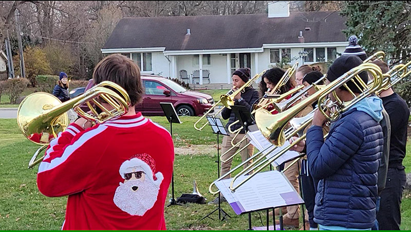 The South Suburban Trombone Choir performs its first set of the afternoon in Flossmoor Park. The group later moved to the lawn of Flossmoor Library to continue entertaining the crowd at Flossmoor's holiday festival. (Eric Crump/H-F Chronicle)