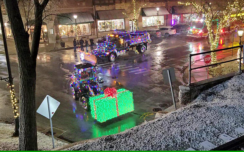 The Flossmoor Holiday Lights Parade turns onto Flossmoor Road to visit the neighborhoods on the east side of the railroad tracks. (Eric Crump/H-F Chronicle)