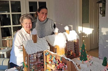 From left, gingerbread artist Janet Gustafson of Flossmoor and Flossmoor Events Manager Stephanie Wright. Wright helped coordinate tours of Gustafson's 2022 gingerbread creation. (Eric Crump/H-F Chronicle)