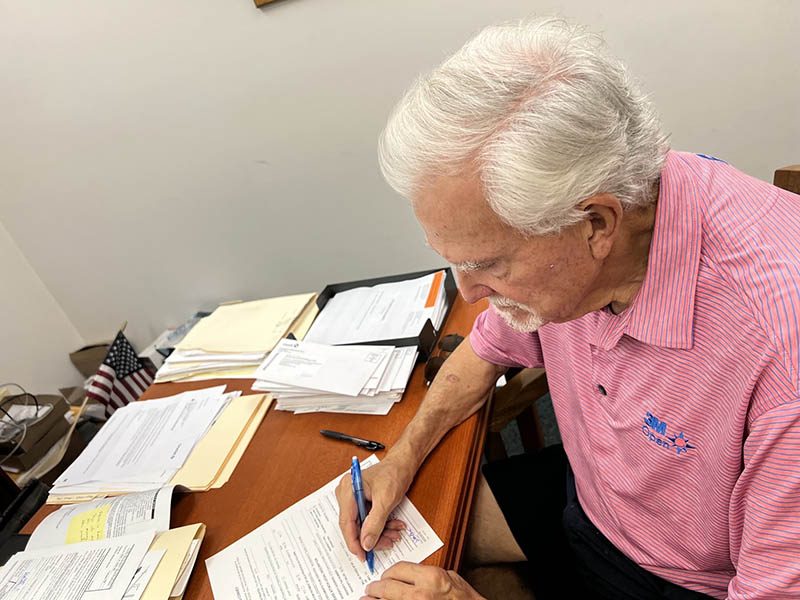 Alvin Wagner Jr. signs the deed for the Wagner Building, 2709 Flossmoor Road, over to the Foundation for the Preservation of Flossmoor History. (Photo provided)
