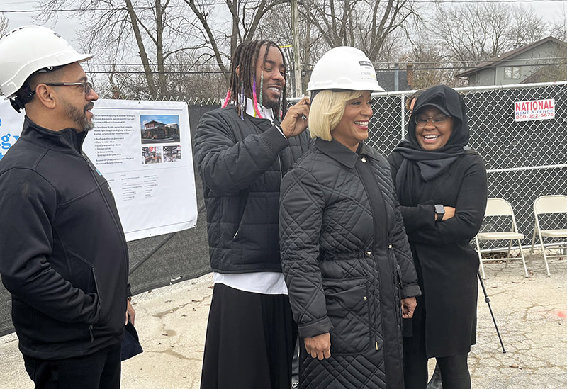 Homewood Brewing co-owner and company spokesperson Carmela Wallace gets help with her hardhat at the groundbreaking ceremony on Friday, Dec. 2. (Nick Ulanowski/H-F Chronicle)