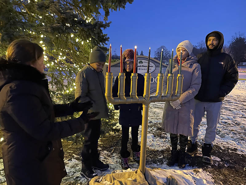 On the second night of the Kwanzaa celebration at Flossmoor Park, Mayor Michelle Nelson introduces the Mitchell Family, (left to right) Gregory, Kathleen, Kimberly and Fredric. (Bill Jones/H-F Chronicle)