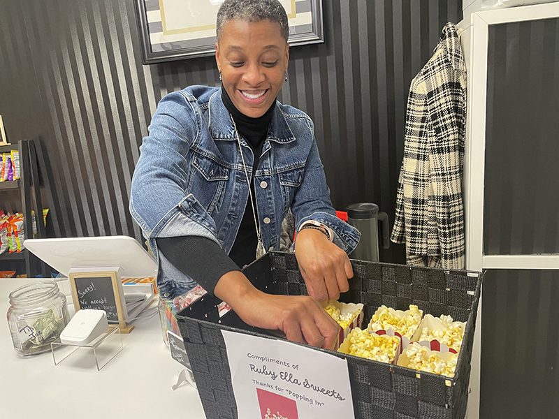 Shawnda DeBose, owner of Ruby Ella Sweets, organizes some complimentary popcorn sleeves on Thursday, Dec. 1, when downtown Flossmoor held a holiday open house. (Bill Jones/H-F Chronicle)