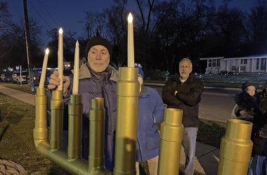 Jeffrey Lippert, of Flossmoor, lights the candles on the menorah at Flossmoor Park on Tuesday, Dec. 20, during the village’s public celebration of the third night of Hanukkah. (Bill Jones/H-F Chronicle)