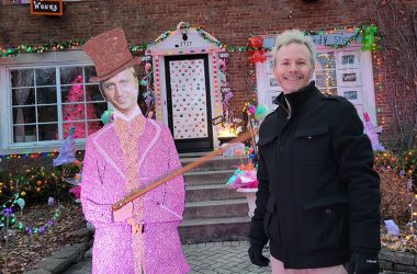 Andy Weberg of Flossmoor poses with the Willie Wonka figure, part of the elaborate Wonka-themed holiday display he and his wife, Lilly, have built over the past four years. (Eric Crump/H-F Chronicle)