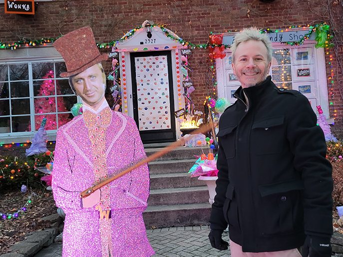 Andy Weberg of Flossmoor poses with the Willie Wonka figure, part of the elaborate Wonka-themed holiday display he and his wife, Lilly, have built over the past four years. (Eric Crump/H-F Chronicle)