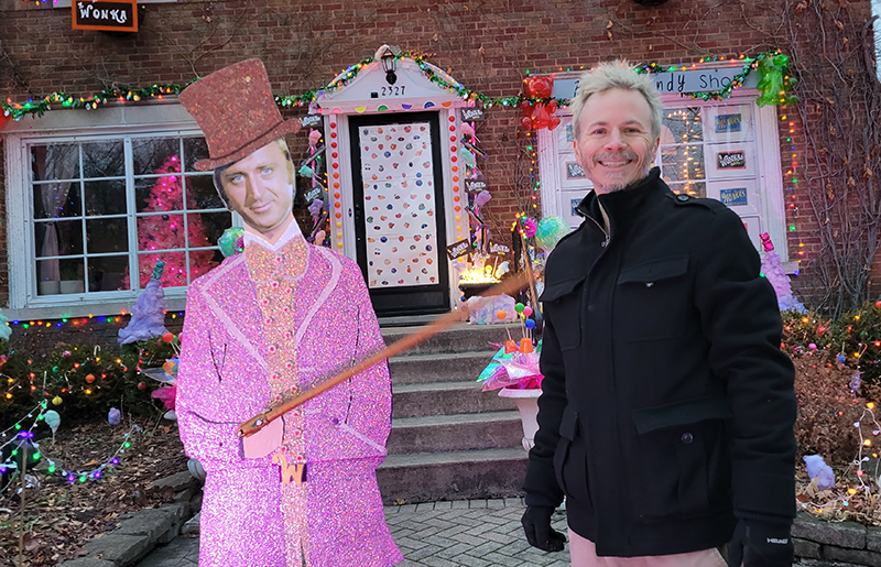 Andy Weberg of Flossmoor poses with the Willie Wonka figure, part of the elaborate Wonka-themed holiday display he and his wife, Lilly, have built over the past four years. (Eric Crump/H-F Chronicle)