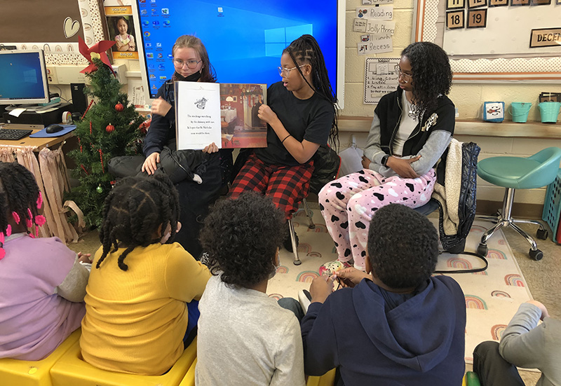 James Hart School eighth graders, from left, Addy Trotter, Amya Ward and Janiah Roper took turns reading "The Night Before Christmas" to students at Willow School. (Marilyn Thomas/H-F Chronicle)