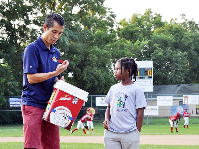 Ashton Rowe helps Bronco League Commissioner James Cheung pull tickets for the raffle before the start of the championship game. (Bill Jones/H-F Chronicle)