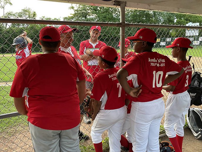 Head coach Pete Williams and team manager Tom Sullivan talk to the Phillies at the start of the championship game. (Bill Jones/H-F Chronicle)