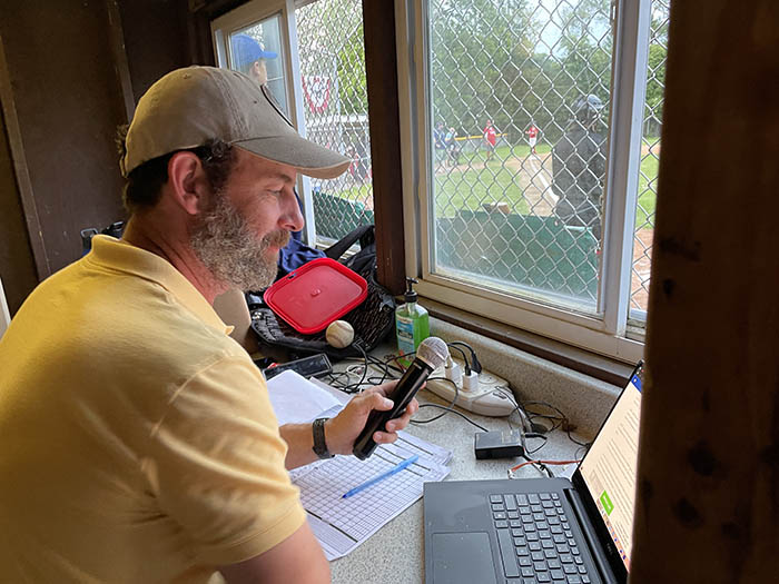 Gary Daggett announces batters and keeps stats during the title game. (Bill Jones/H-F Chronicle)