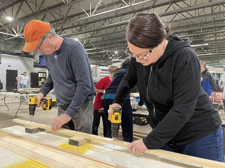 Kevin Gallagher and Jodie Lawrence, both of Flossmoor, drill holes on Saturday, Jan. 14, during a Sleep in Heavenly Peace bed build held at the Flossmoor Public Works garage. (Bill Jones/H-F Chronicle)