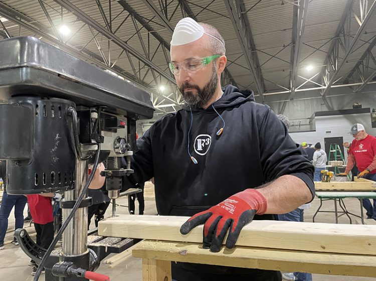 Robert Babcock, with a group from F3 Southsid3, drills a hole into a piece of wood on Saturday, Jan. 14, during a Sleep in Heavenly Peace and Village of Flossmoor bed build. (Bill Jones/H-F Chronicle)