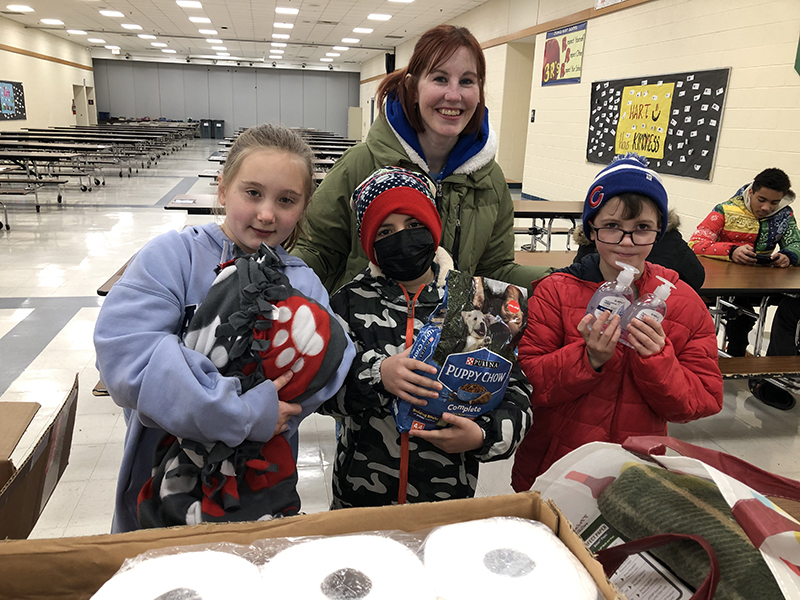 Churchill School students, from left, Cora Donohue Alex Castellanos and Ollie Green and teacher Karen Lindquist help pack up Items for the dogs and cats at the South Suburban Human Society. The students worked as members of the Early Act Club at Churchill during Homewood District 153's Martin Luther King Jr Day of Service event. (Marilyn Thomas/H-F Chronicle)