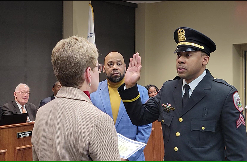 Dennis Leaks takes the oath of office Jan. 10 after being promoted to sergeant with the Homewood Police Department while his father, Dennis Leaks Sr., looks on. (Eric Crump/H-F Chronicle)