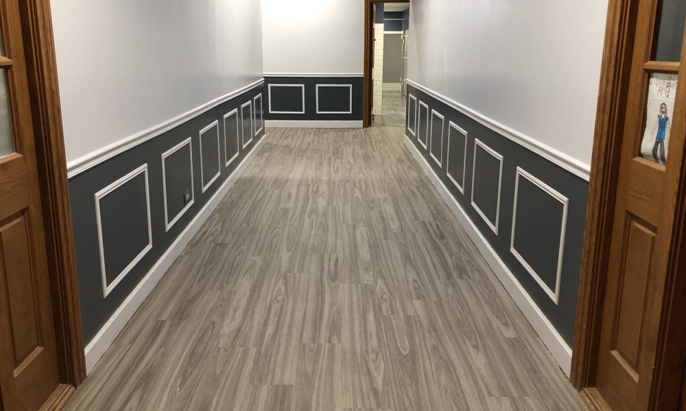 A first floor hallway at the park district's Irwin Center has been updated. The wood paneling has been replaced with a shade of blue highlighted with white accent boxes. The carpeting has been replaced with flooring. (Marilyn Thomas/H-F Chronicle)