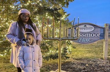 Marianne Powell reflects on how faith guided the past year of her life during a public Kwanzaa celebration in Flossmoor Park. Powell’s daughter JaOni Rousseau stands with her. (Bill Jones/H-F Chronicle)