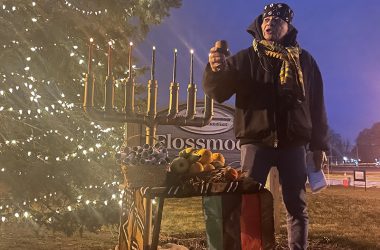 Leonard Harris, of Flossmoor, lifts a cup with what would typically be shared communal libations on Saturday, Dec. 31, during the sixth night of Kwanzaa. (Bill Jones/H-F Chronicle)