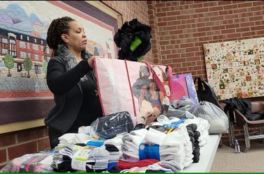Katari Coleman, Plan4Success education director, sorts socks to be donated to area shelters. (Eric Crump/H-F Chronicle)