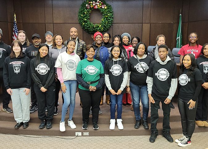 Plan4Success officials and a crew of volunteers pose for a photo in the board room at Flossmoor village hall before getting to work on their MLK Day of Service projects Monday, Jan. 16. (Eric Crump/H-F Chronicle)