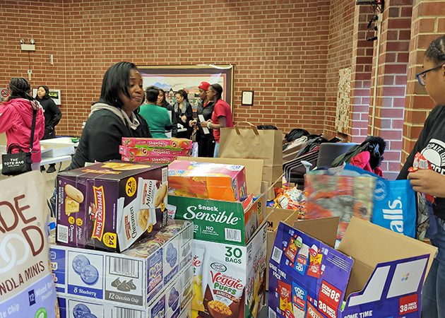 Crystal Cunningham, left, and Sharidan Rickmon sort treats that will be distributed to care packages for first responders. (Eric Crump/H-F Chronicle)
