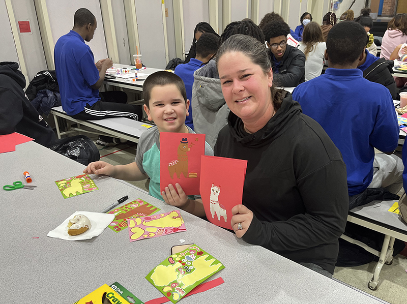 Julie Huisman, safety aide at Serena Hills, and Hunter Huisman, her son, a third grader at Serena Hills, show off some of the Valentines Day cards they made. (Nick Ulanowski/H-F Chronicle)