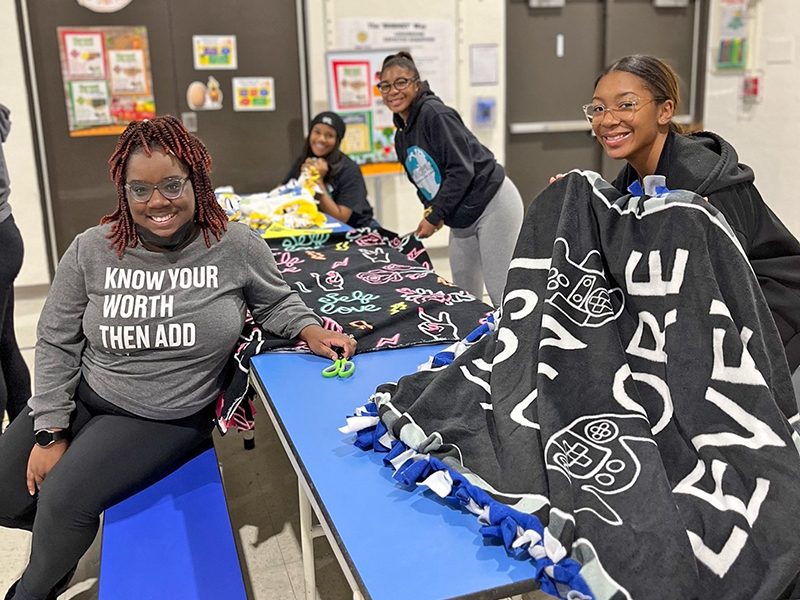 You Matter 2 volunteers, Saquenna Watkins, left, Mackenzie Ray, Sari Zinnerman and Sani Zinnerman help with the organization's annual MLK Day of Service projects at Heather Hill School in Flossmoor. (Nuha Abdessalam/H-F Chronicle)