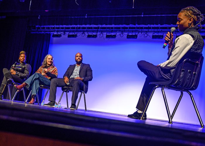 A Pursuing the Dream emcee moderates an author panel with India Anderson, Sahar Mustafah and Evan Roberts. (Andrew Burke-Stevenson/H-F Chronicle)