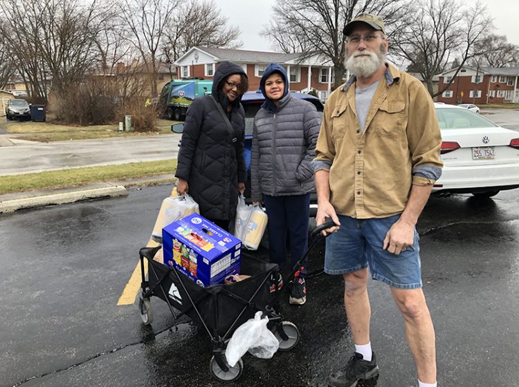 Donations were brought in and wheeled in with a portable wagon by, from left, Sorena Lee Jack Schott and Dan Warning who came to the District 153 drop-off site at James Hart School for the Martin Luther King Jr. Day of Service. Students collected for Respond Now, ANEW and the South Suburban Humane Society. (Marilyn Thomas/H-F Chronicle)