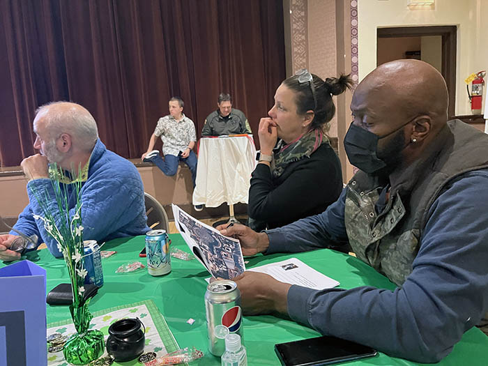 Ryan Right, left, Stephanie Wright and retired U.S Army veteran Zarrod Beck, right, are deep in thought while participating in the trivia night fundraiser for the Flossmoor Veterans Memorial project. (Nick Ulanowski/H-F Chronicle)