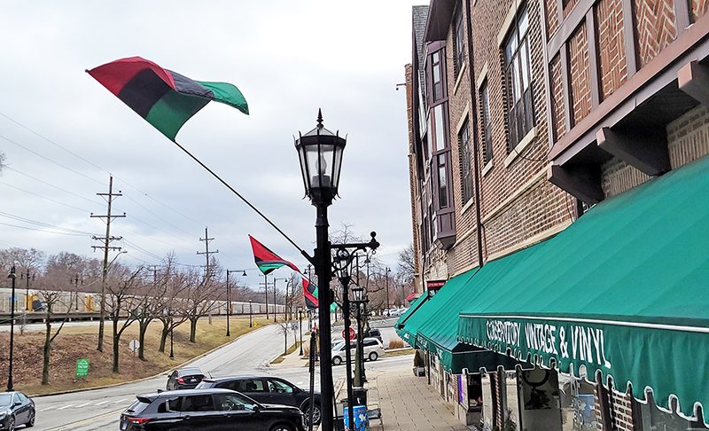 Red, black and green Pan African flags fly in downtown Flossmoor during Black History Month. (Eric Crump/H-F Chronicle)