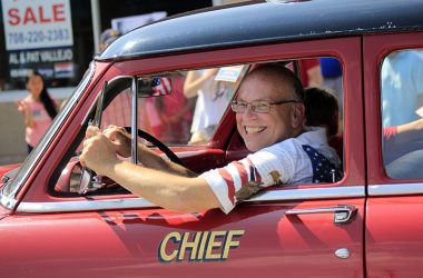 Jim Wright waves to the crowd from his 1954 Ford fire chief car during Homewood's 2018 4th of July parade. He was active in the A’s R Us vintage auto club and was a regular participant in local parades and festivals. (Chronicle file photo)
