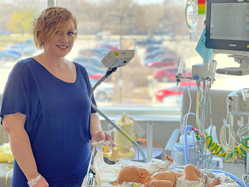 Heather Carter stands beside her son, Liam, at the Franciscan Health Family Birth Center in Olympia Fields. Carter said having the AngelEye live-stream video camera system helped her stay connected to her son while he was in the Special Care Nursery. (Provided photo)