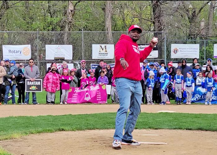 Homewood-Flossmoor High School Principal Clinton Alexander throws out the ceremonial first pitch to help open the 2023 season of Flossmoor Baseball and Softball. (Eric Crump/H-F Chronicle)